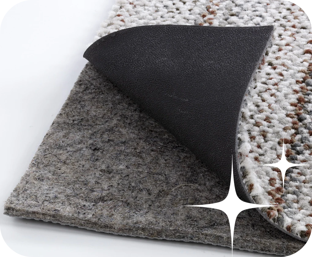 Close up of area rug peeled back to reveal a rug pad | Lloyd's Carpets & Draperies