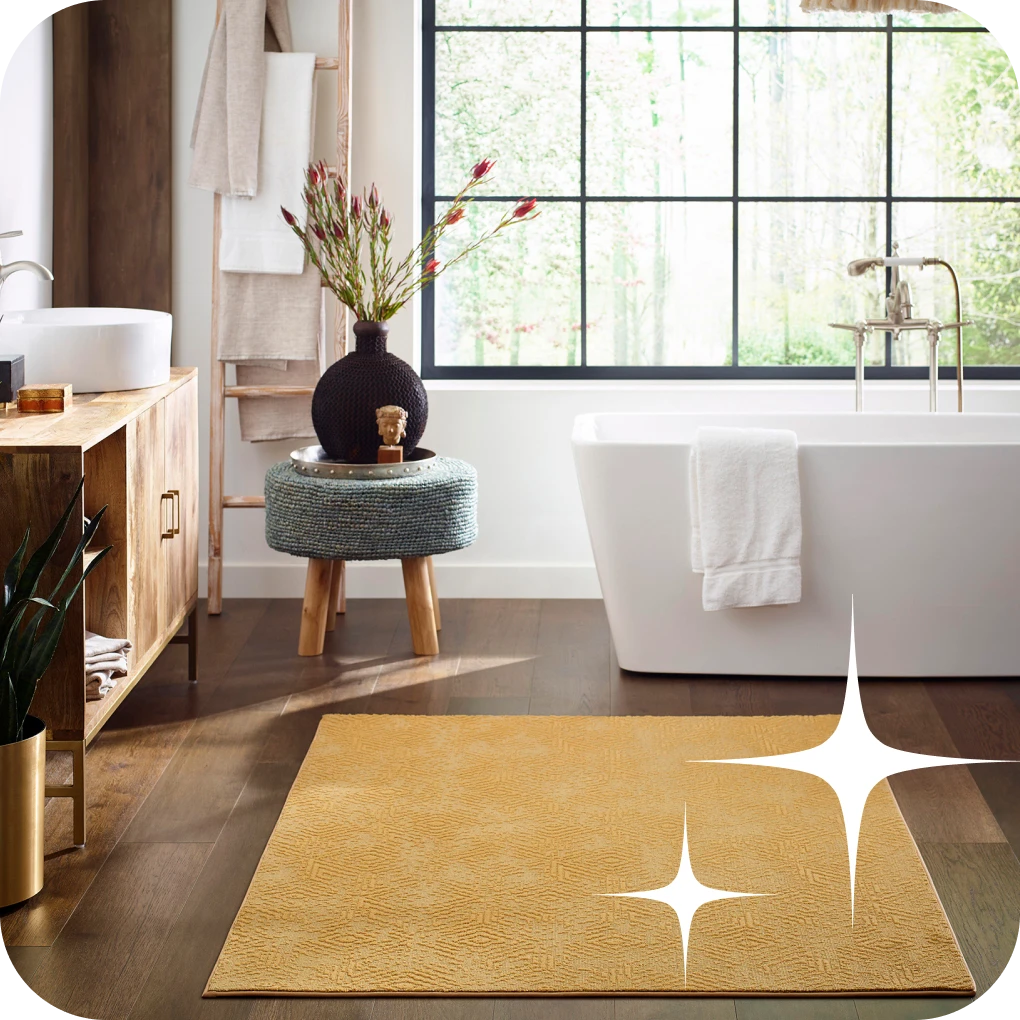 Yellow area rug in modern bathroom with dark flooring and stand-alone tub | Lloyd's Carpets & Draperies