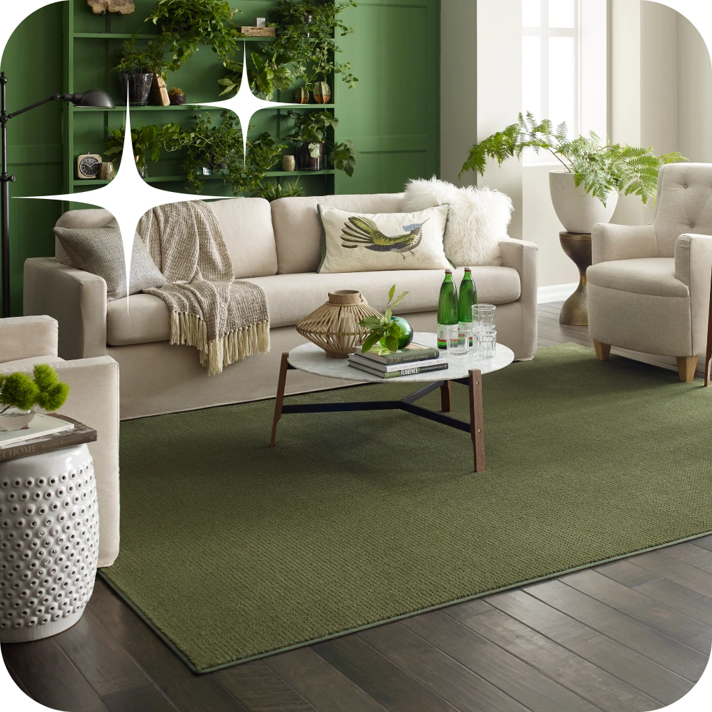 Green area rug in living space with green cabinetry and white couch | Lloyd's Carpets & Draperies