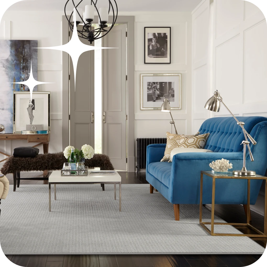 Light textured area rug in contemporary living room with blue couch and silver decorations | Lloyd's Carpets & Draperies