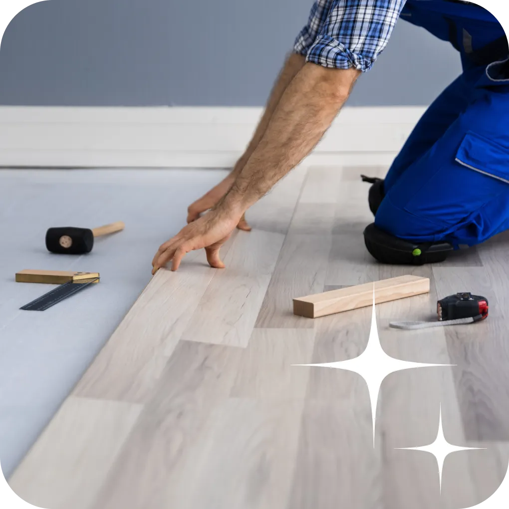 Worker installing laminate flooring | Lloyd's Carpets & Draperies